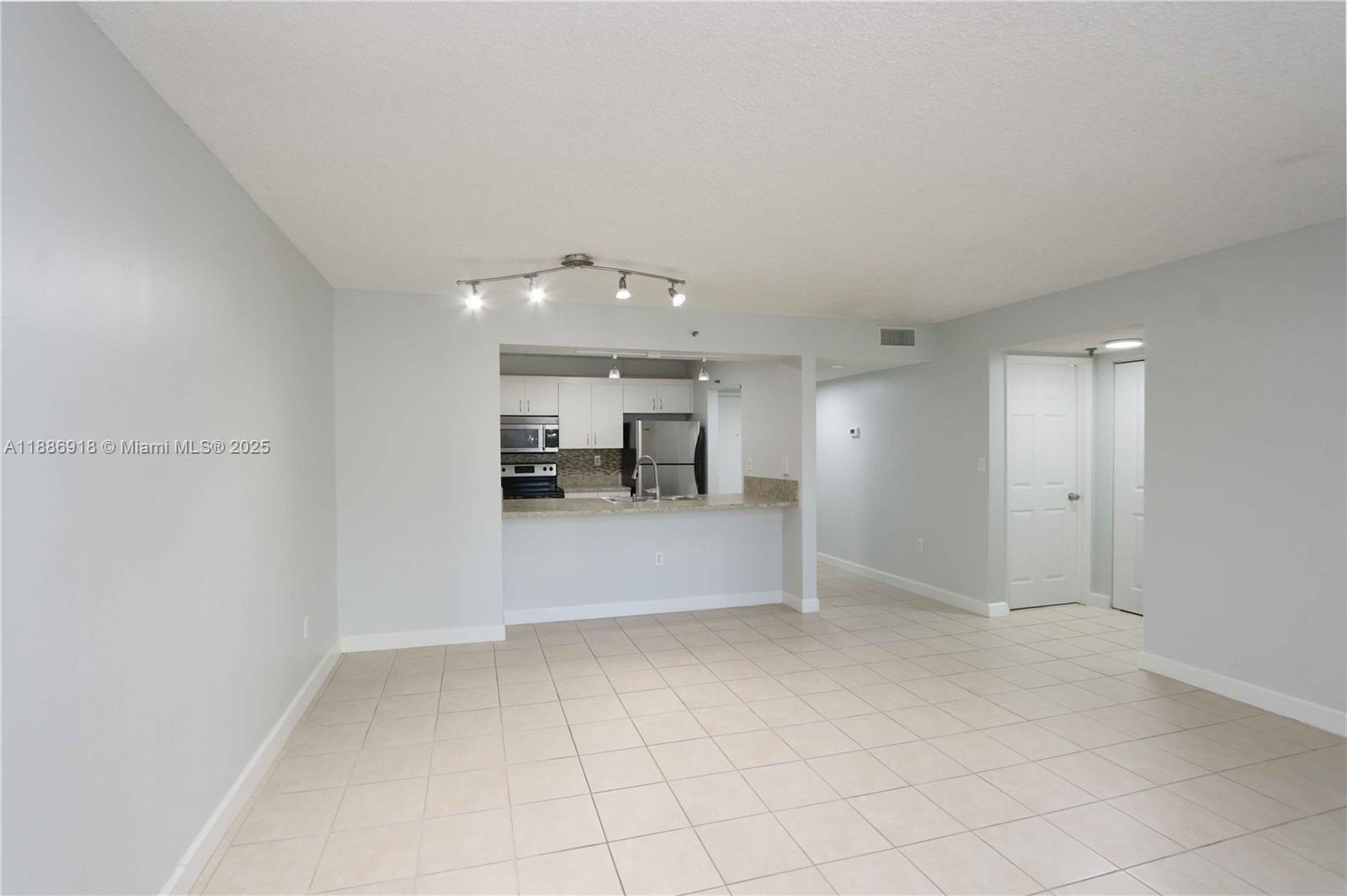 850 North Miami Avenue, Unit W305 Miami, FL 33136 - Photo 9 of 27 a view of kitchen with furniture and a refrigerator