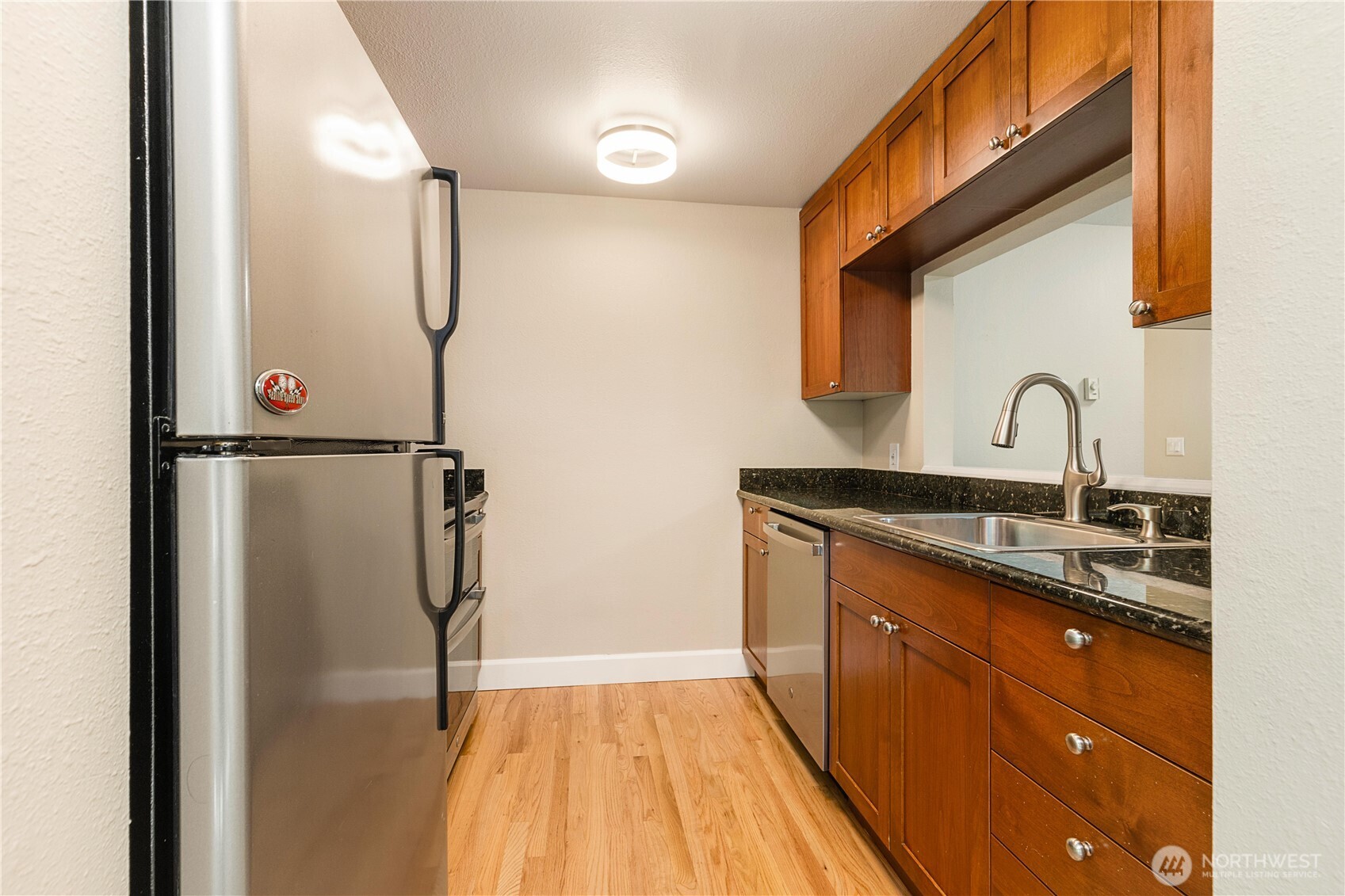 755 5th Avenue Northwest, Unit D202 Issaquah, WA 98027 - Photo 11 of 25 a kitchen with a sink and a refrigerator