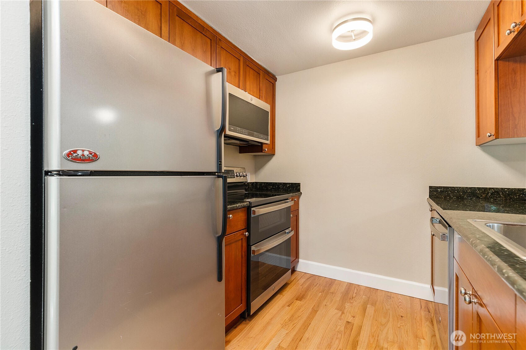 755 5th Avenue Northwest, Unit D202 Issaquah, WA 98027 - Photo 13 of 25 a kitchen with a refrigerator and a stove
