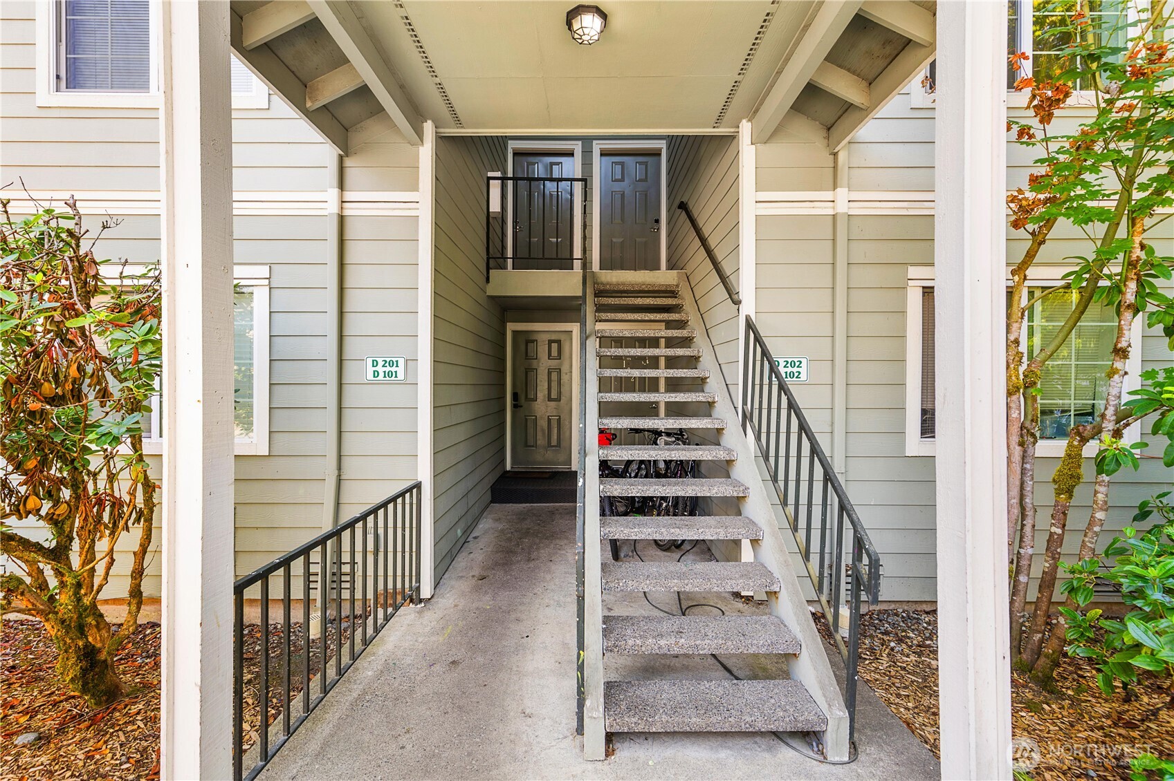 755 5th Avenue Northwest, Unit D202 Issaquah, WA 98027 - Photo 2 of 25 a view of a balcony with wooden floor and stairs