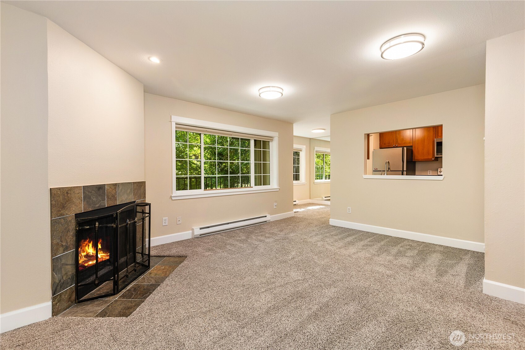 755 5th Avenue Northwest, Unit D202 Issaquah, WA 98027 - Photo 6 of 25 an empty room with windows and fireplace