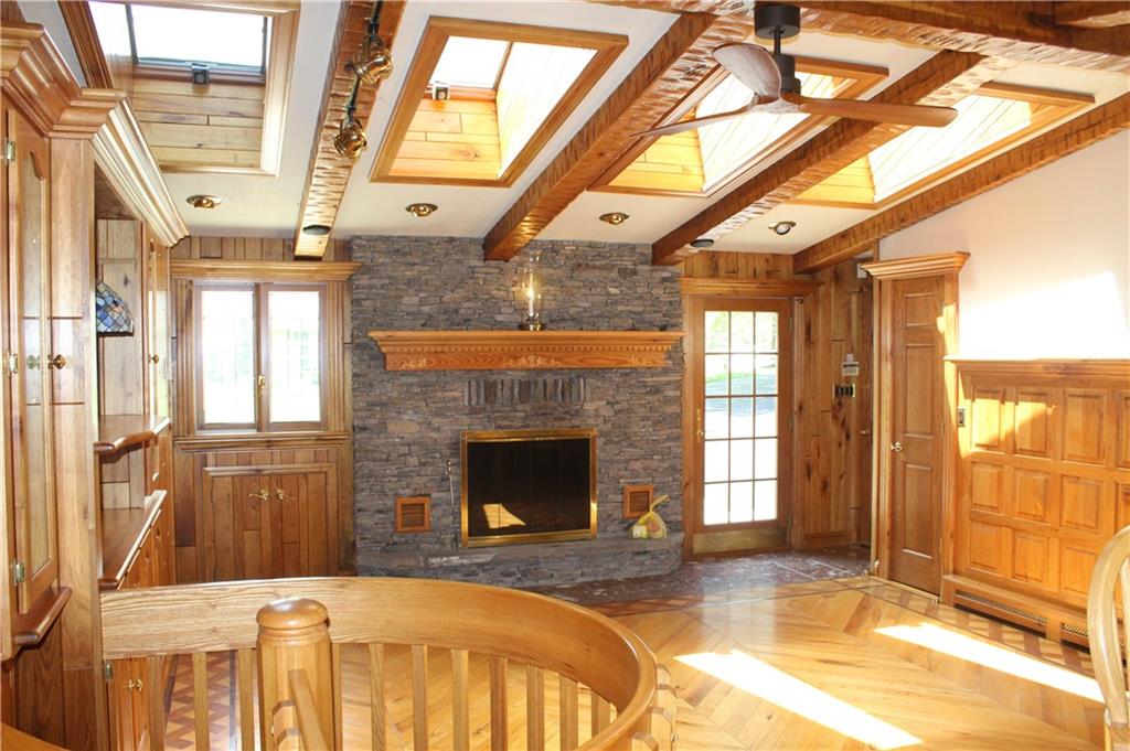 119 Fir Street Rillton, PA 15678 - Photo 8 of 16 Bright main floor game room with a wood burning fireplace and retractable sunlight windows