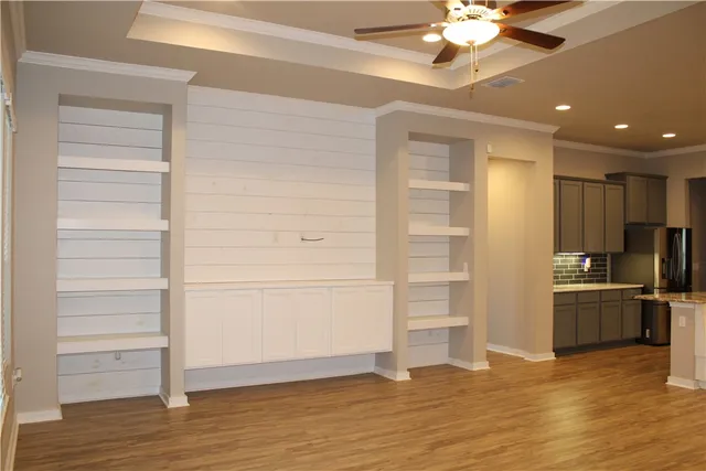 a view of a kitchen with a refrigerator and a stove top oven