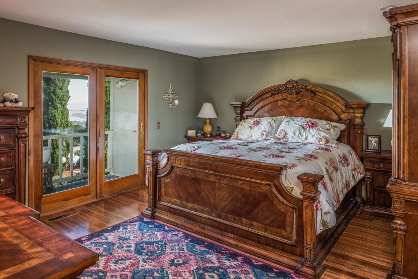 12765 Sundance Lane Carmel Valley, CA 93924 - Photo 16 of 43 a bedroom with a bed and wooden floor