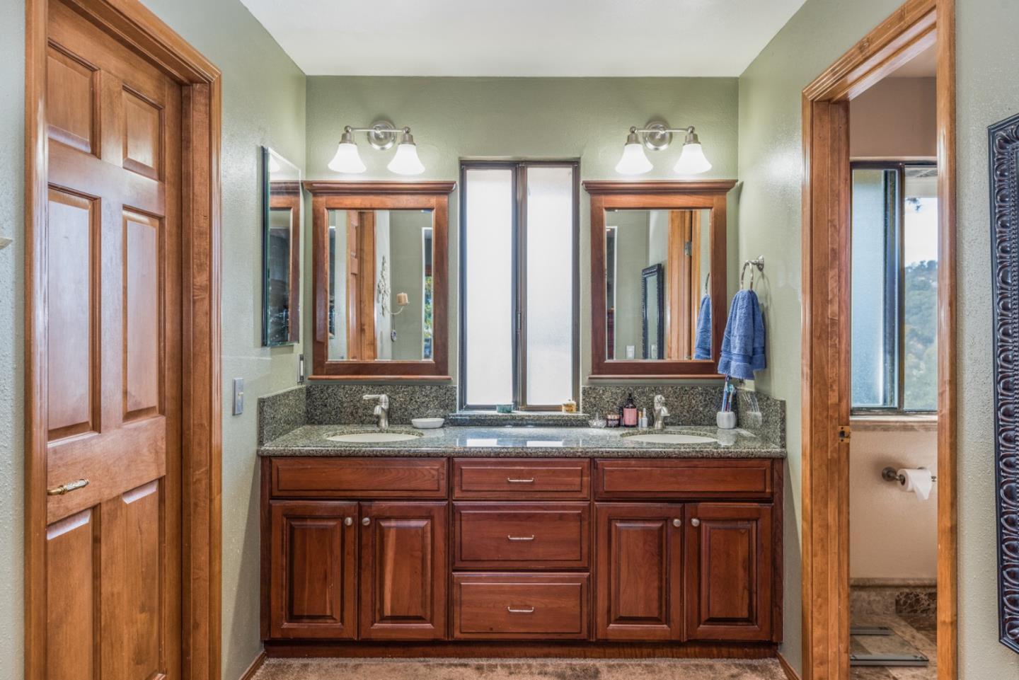12765 Sundance Lane Carmel Valley, CA 93924 - Photo 17 of 43 a bathroom with double vanity and a mirror