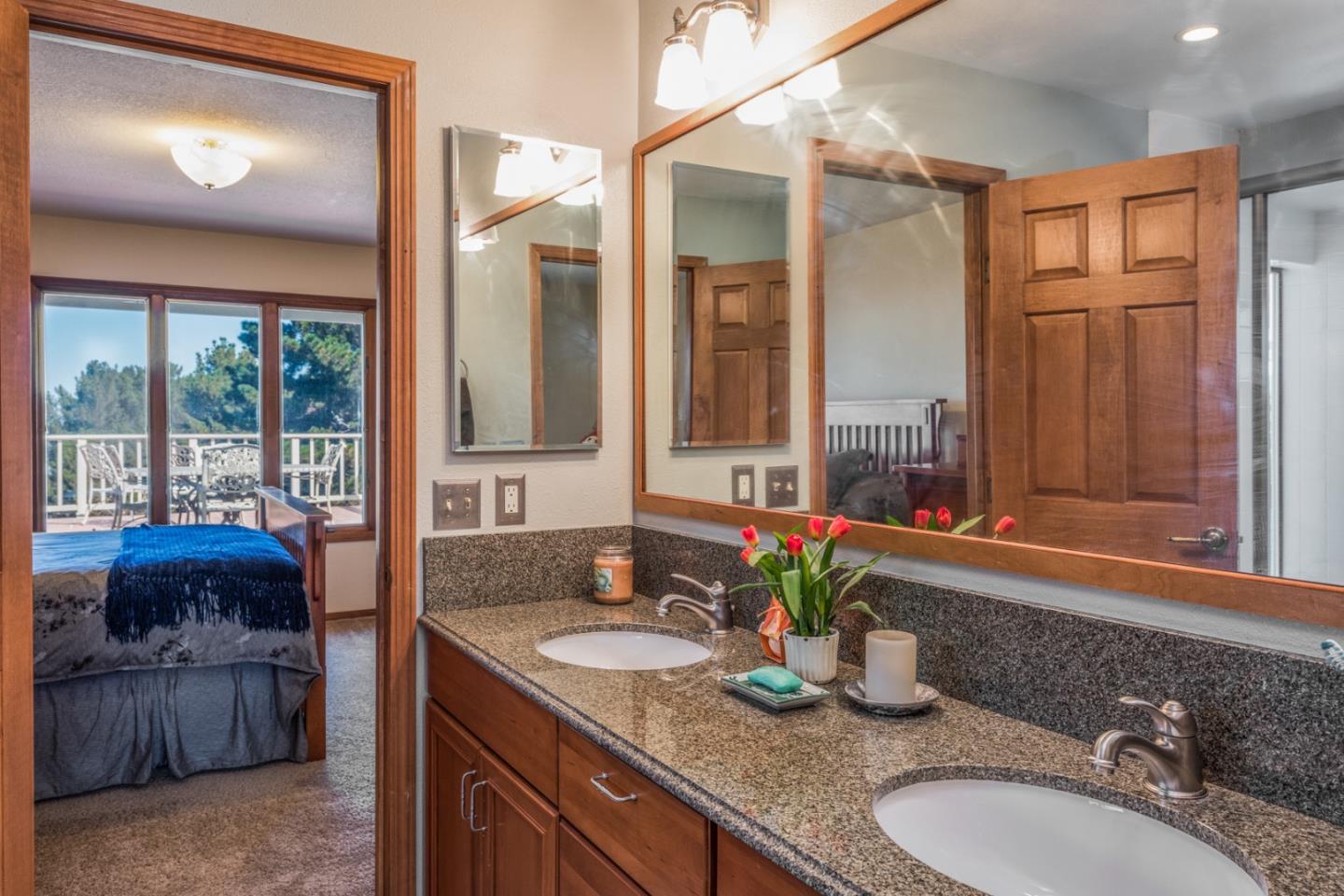 12765 Sundance Lane Carmel Valley, CA 93924 - Photo 19 of 43 a bathroom with a granite countertop sink a mirror and a shower