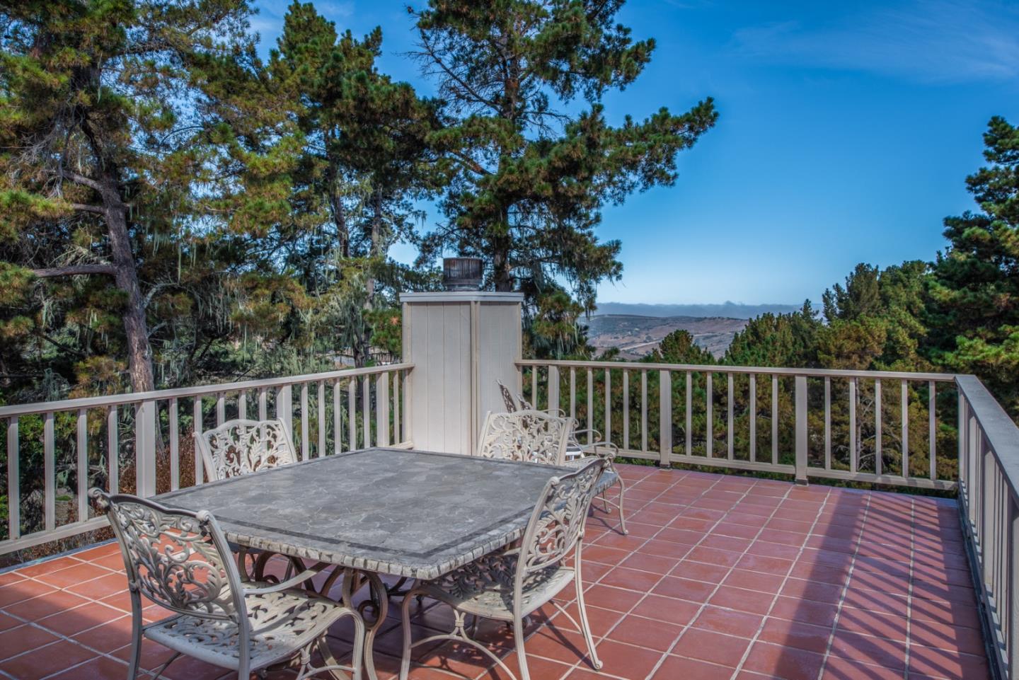12765 Sundance Lane Carmel Valley, CA 93924 - Photo 27 of 43 a balcony with wooden floor table and chairs