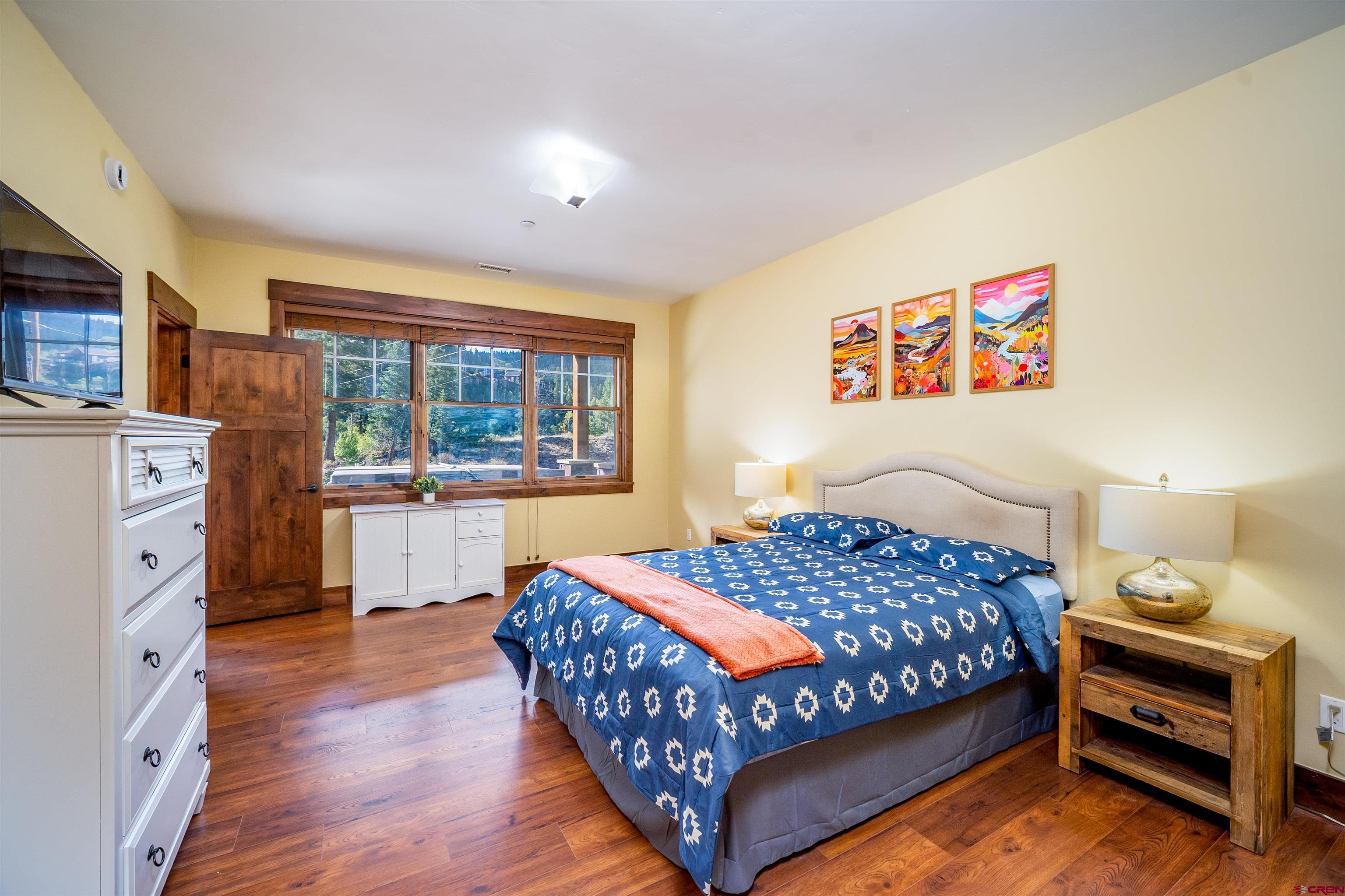 259 Engineer Drive Durango, CO 81301 - Photo 13 of 40 a bedroom with a bed and a dresser next to a window