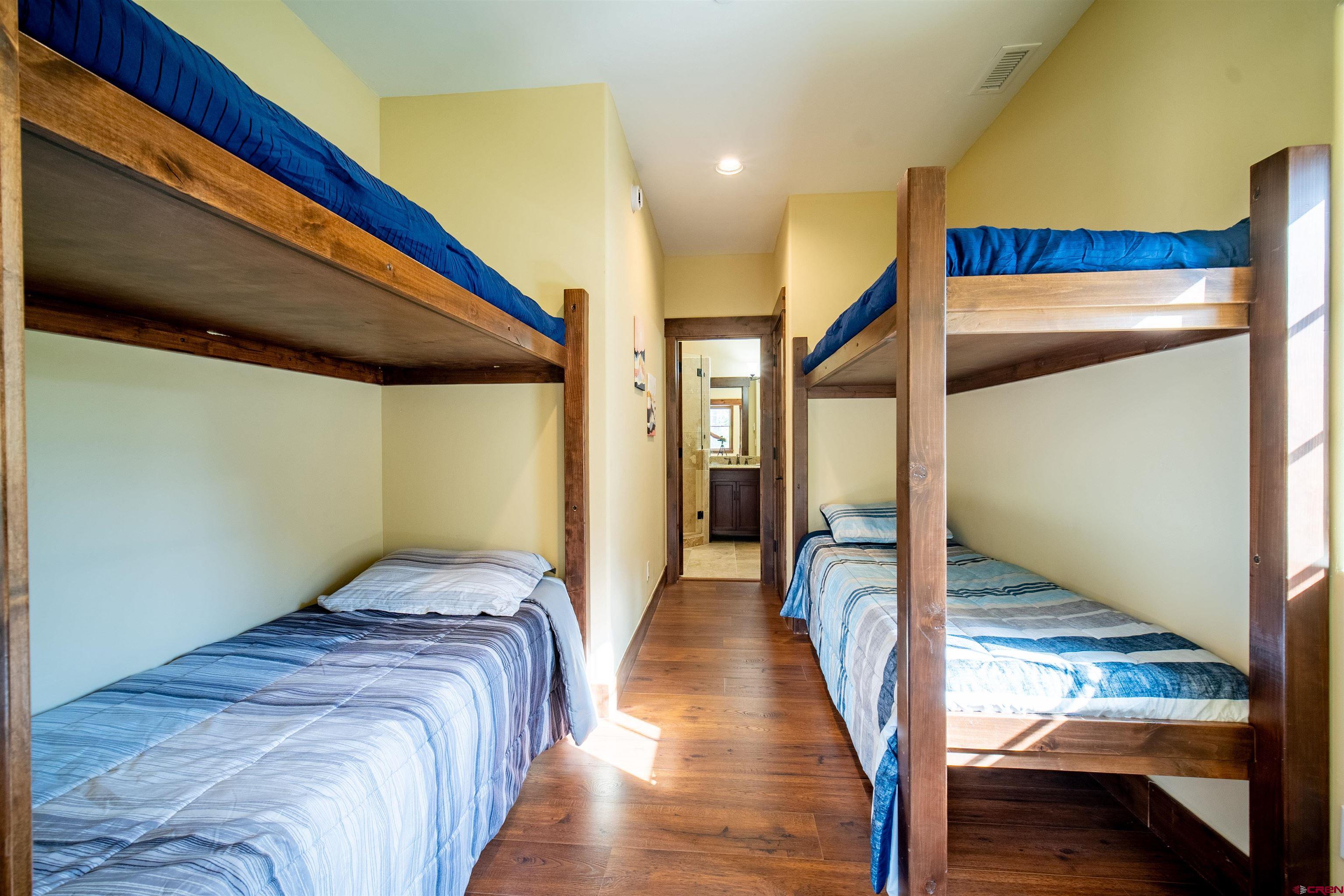 259 Engineer Drive Durango, CO 81301 - Photo 15 of 40 a bedroom with a bed and a view of wooden floor