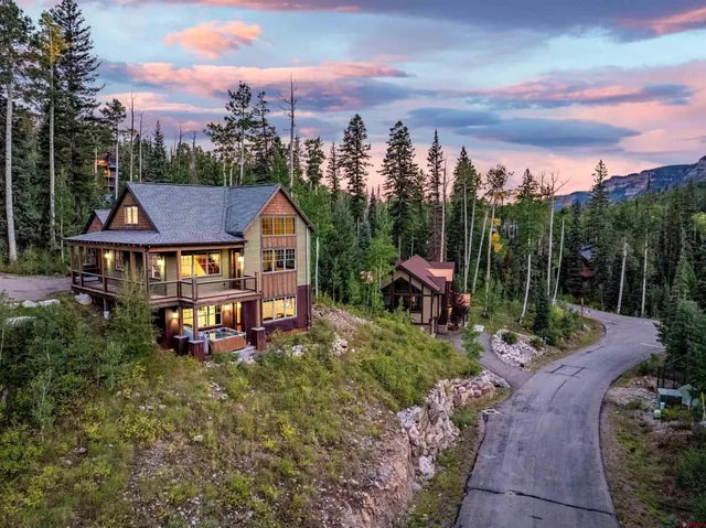 an aerial view of a house with outdoor space swimming pool and mountains