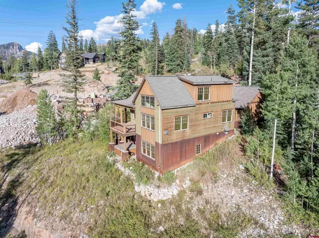 a aerial view of a house with a yard