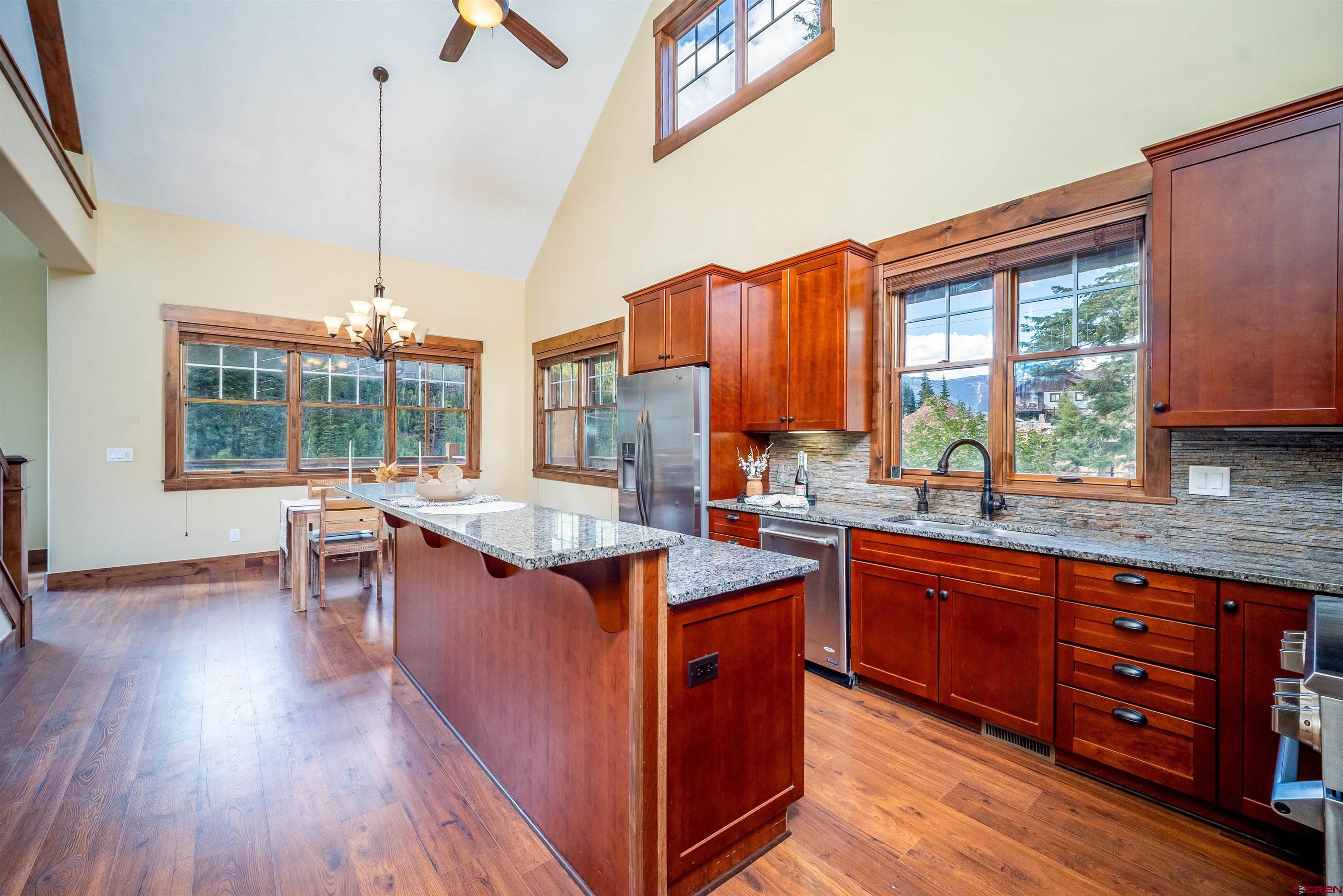 259 Engineer Drive Durango, CO 81301 - Photo 4 of 40 a kitchen with stainless steel appliances granite countertop wooden floors and sink