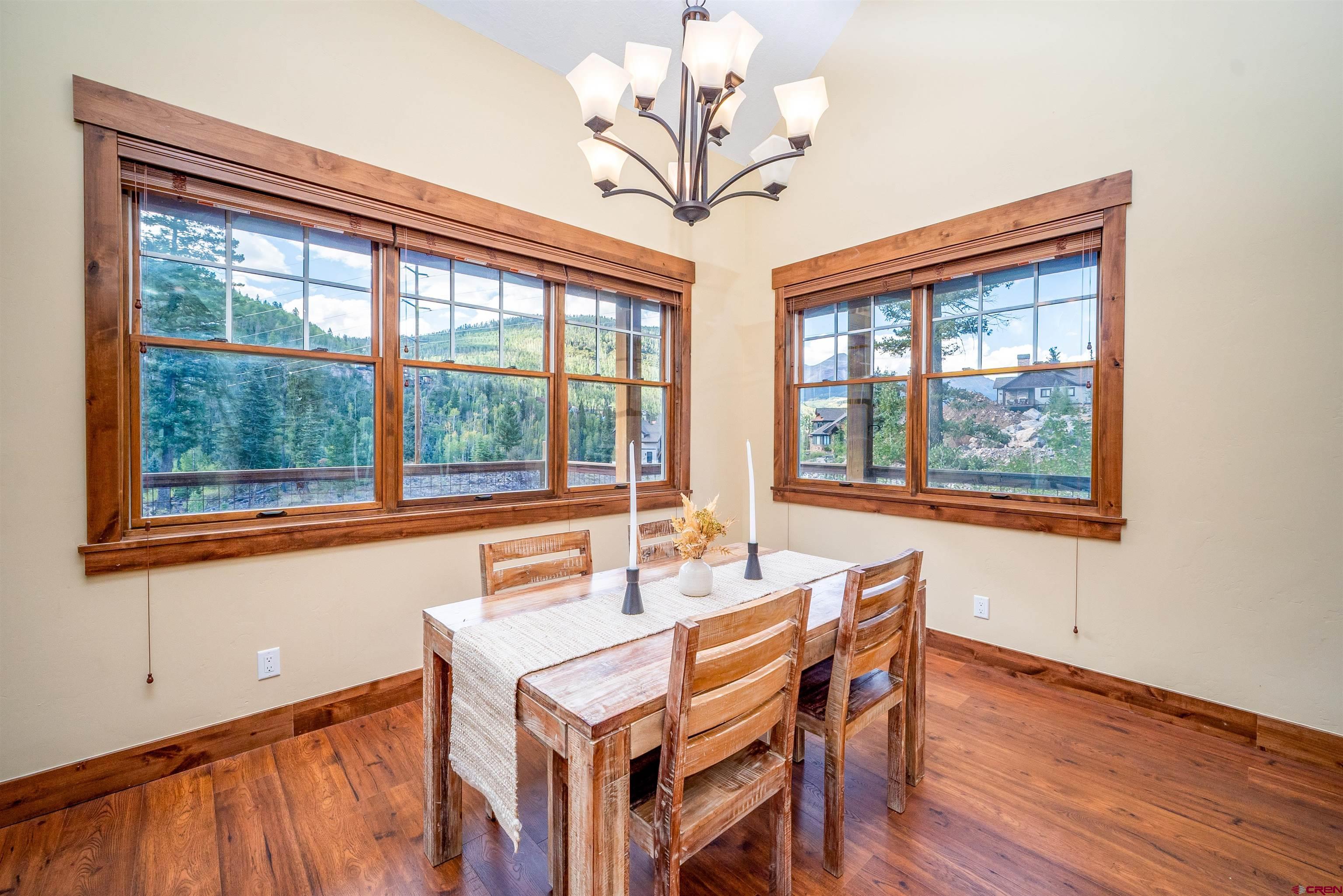 259 Engineer Drive Durango, CO 81301 - Photo 5 of 40 a dining room with furniture a chandelier and wooden floor