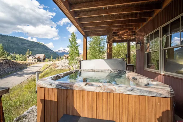 an aerial view of a house with swimming pool garden and trees