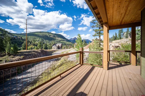 a view of a house with wooden fence