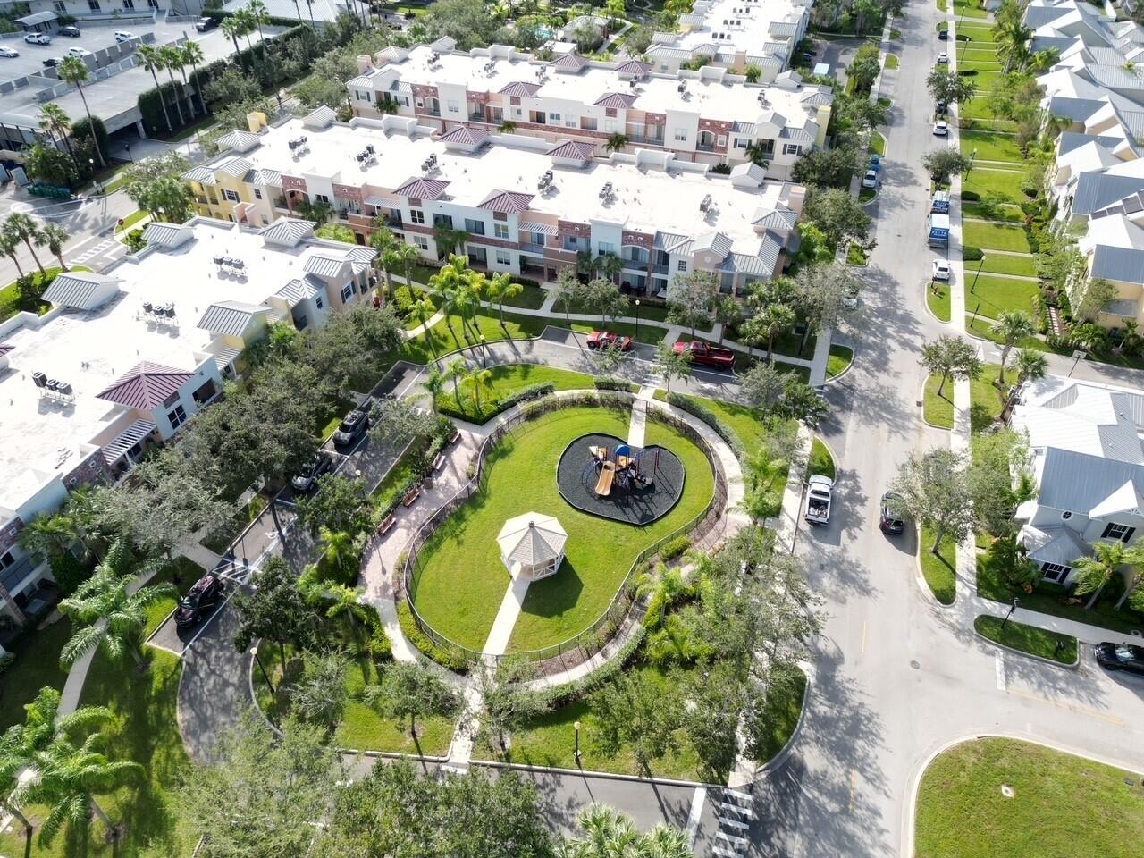 10560 Southwest Stephanie Way, Unit 1206 Port St. Lucie, FL 34987 - Photo 23 of 23 an aerial view of a swimming pool with a yard and plants