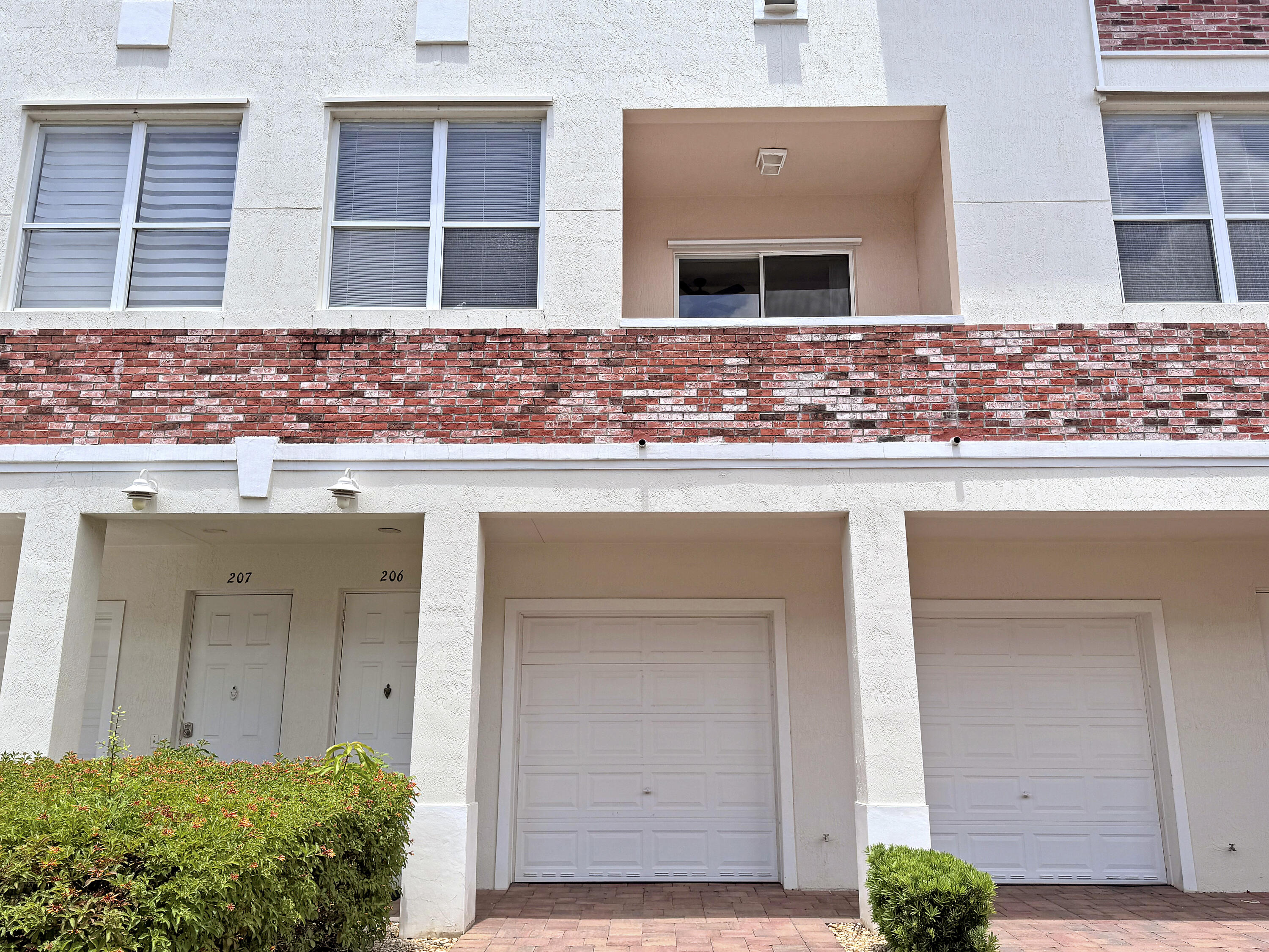 10560 Southwest Stephanie Way, Unit 1206 Port St. Lucie, FL 34987 - Photo 3 of 23 a front view of house with yard