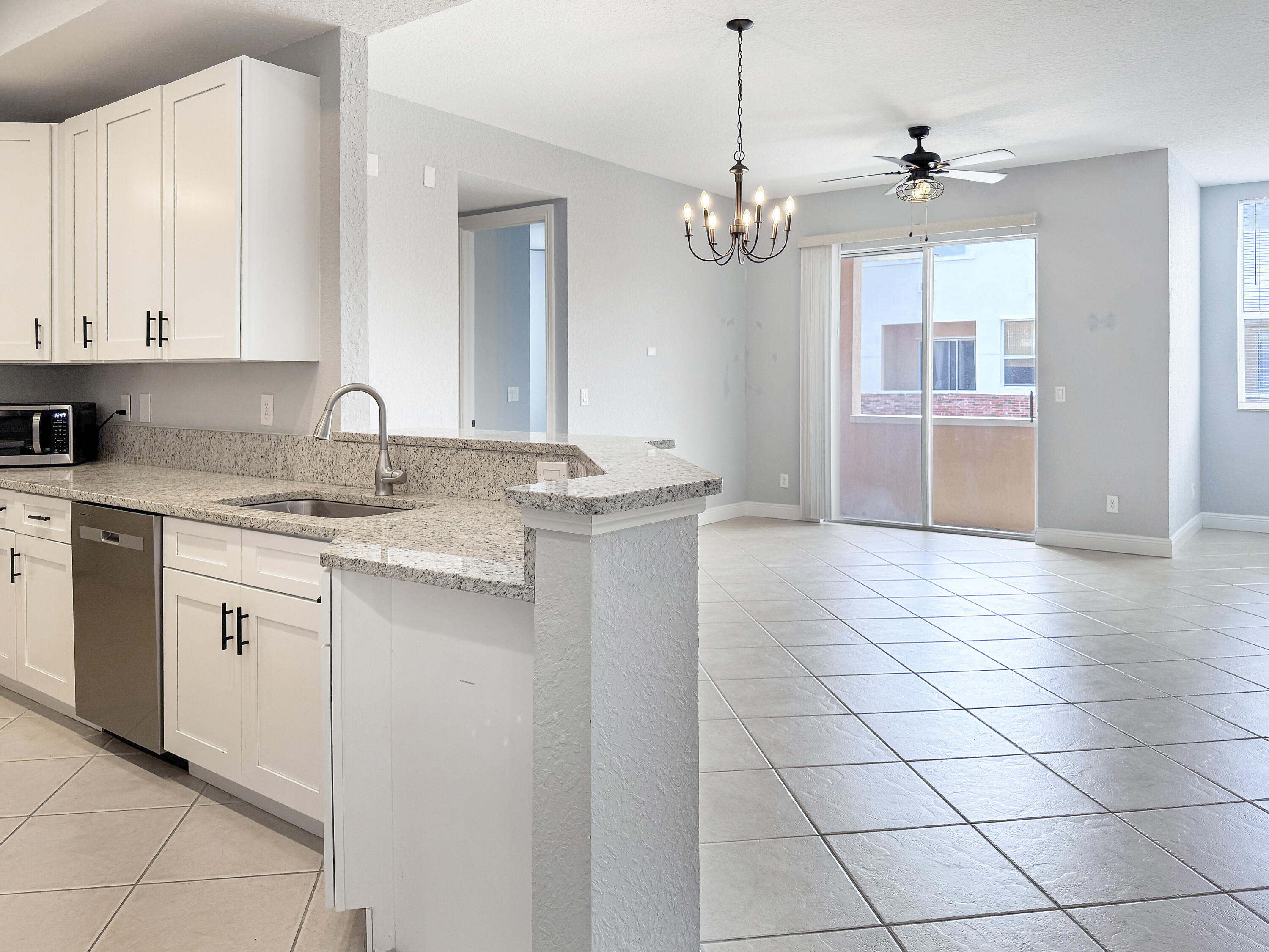 10560 Southwest Stephanie Way, Unit 1206 Port St. Lucie, FL 34987 - Photo 6 of 23 a kitchen with a sink cabinets and window