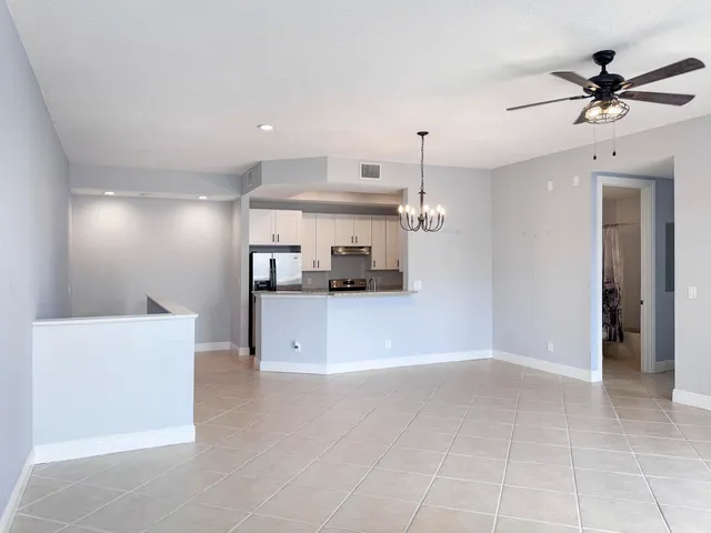 a view of a kitchen with a sink and a ceiling fan