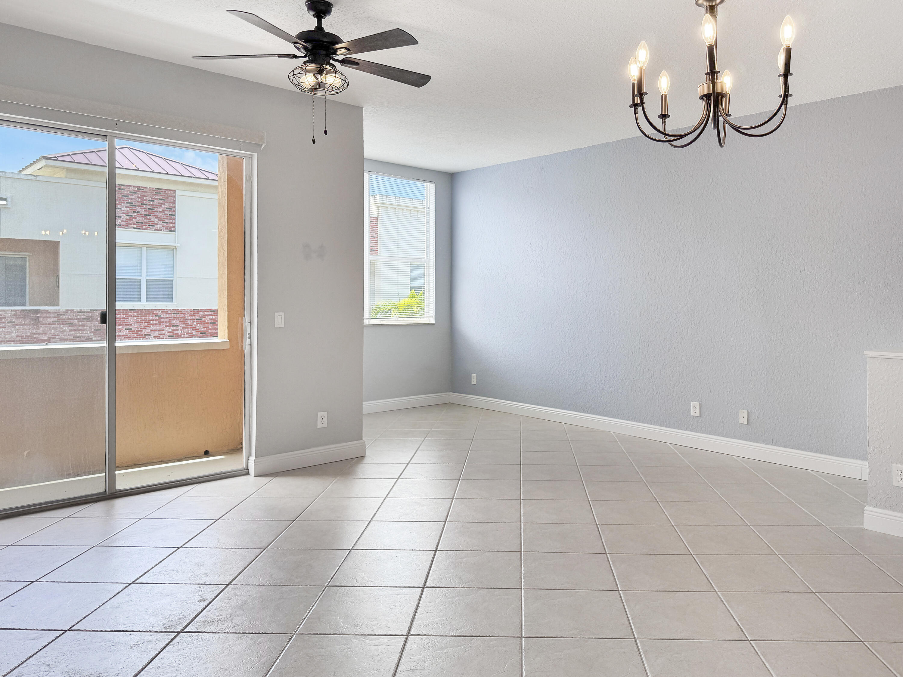 10560 Southwest Stephanie Way, Unit 1206 Port St. Lucie, FL 34987 - Photo 8 of 23 an empty room with windows and fan