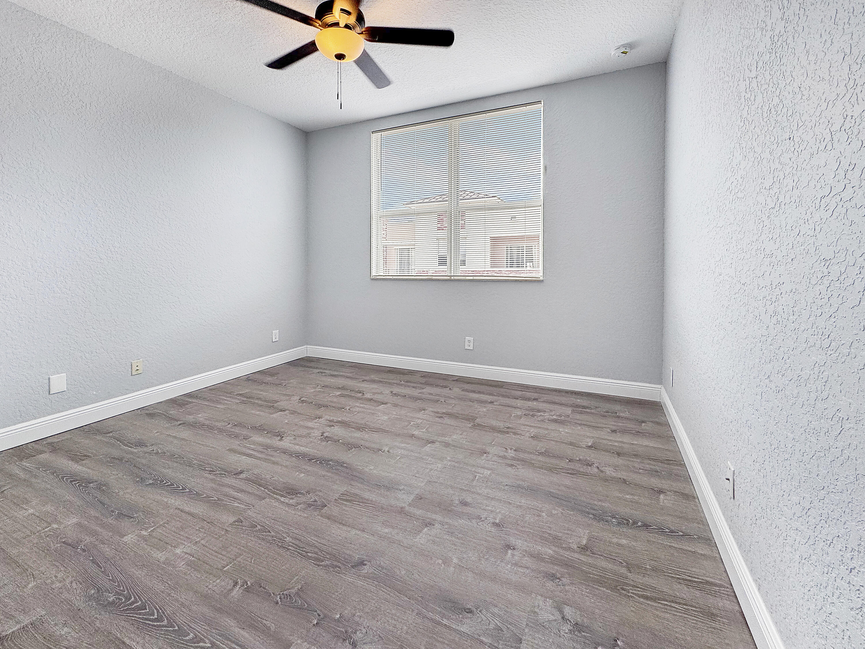 10560 Southwest Stephanie Way, Unit 1206 Port St. Lucie, FL 34987 - Photo 9 of 23 wooden floor in an empty room with a window