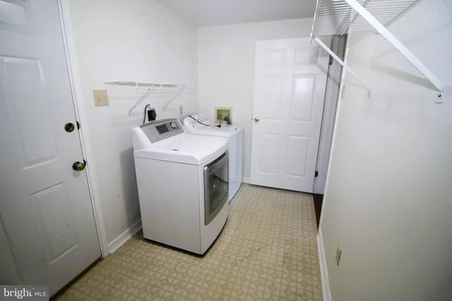 a utility room with cabinets washer and dryer