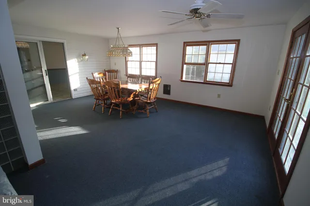 a view of a dining room with furniture and window