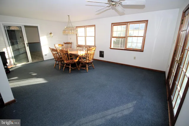 wooden view of a livingroom with furniture and a window