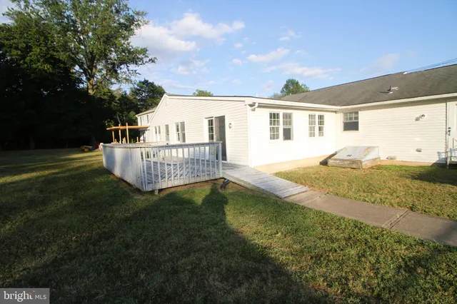 a view of a house with a yard and sitting area