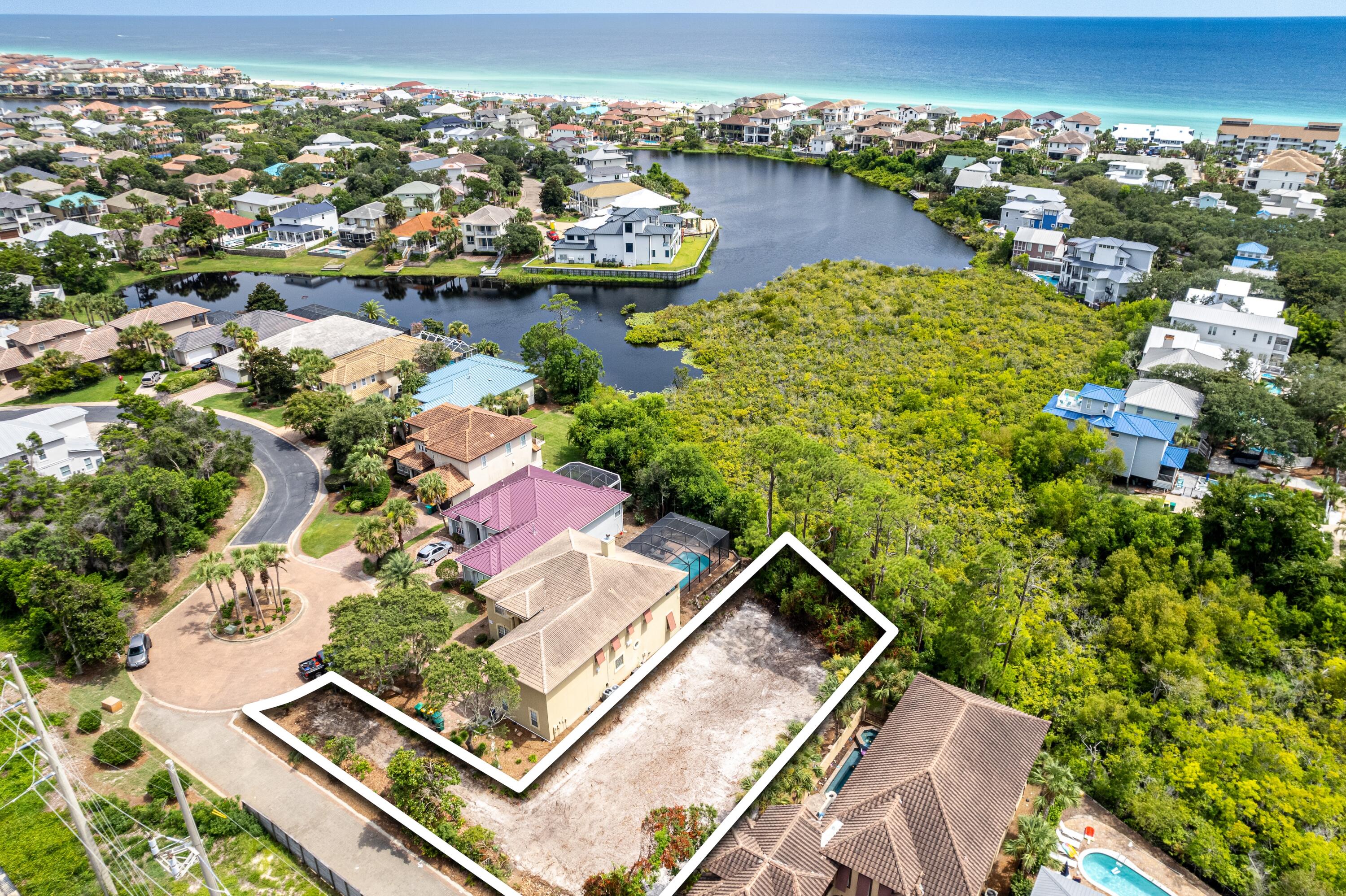 4600 Paradise Isle Destin, FL 32541 - Photo 1 of 8 an aerial view of a house with a lake view