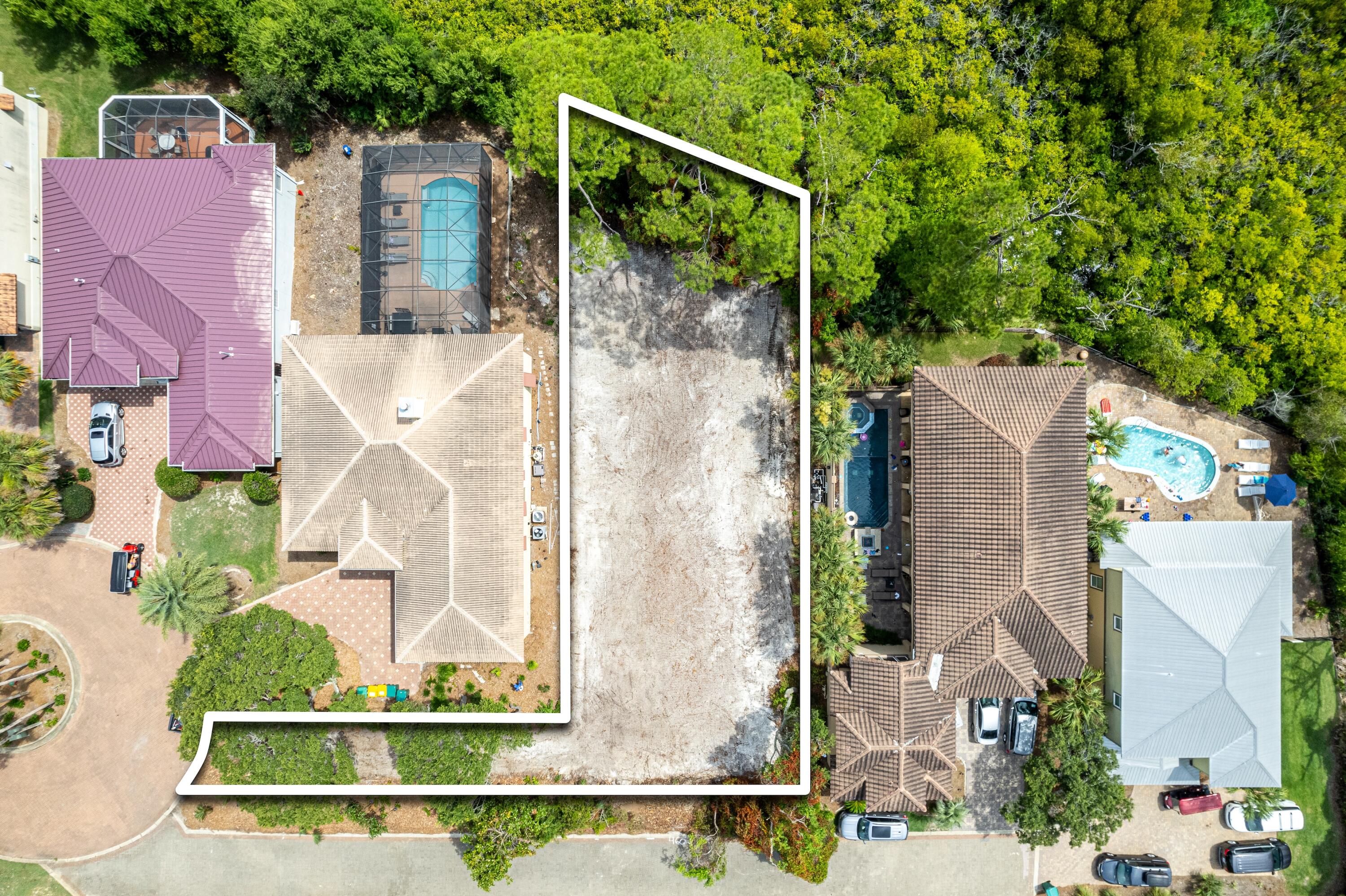 4600 Paradise Isle Destin, FL 32541 - Photo 2 of 8 an aerial view of a house with a yard and large tree