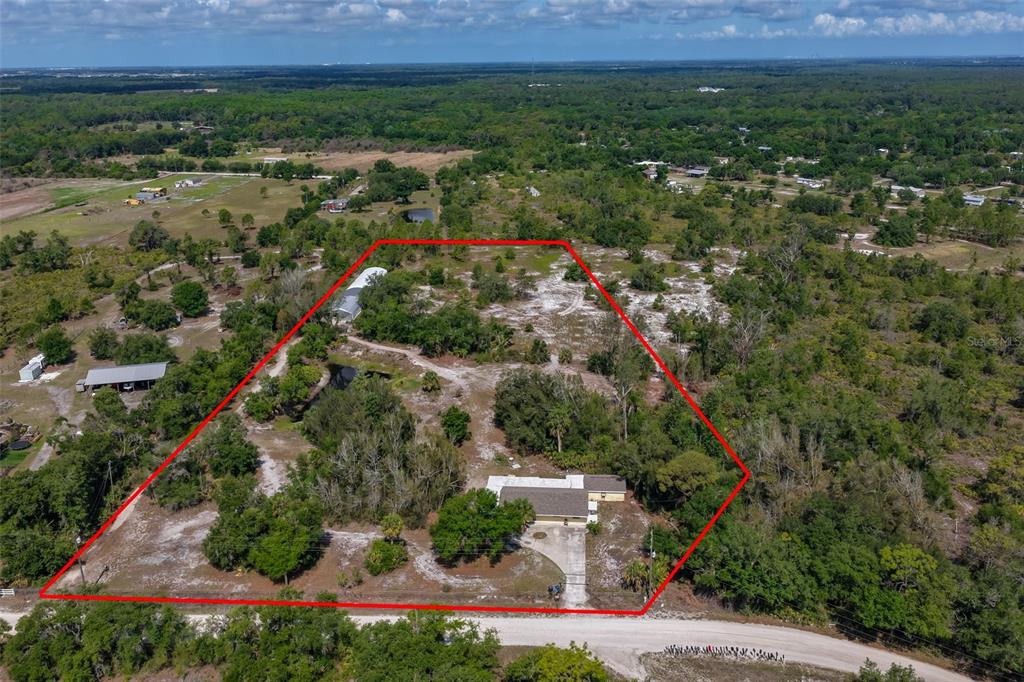 14451 Highland Road Wimauma, FL 33598 - Photo 4 of 80 an aerial view of residential house and outdoor space