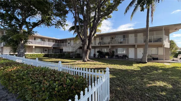 a view of a house with swimming pool and sitting area