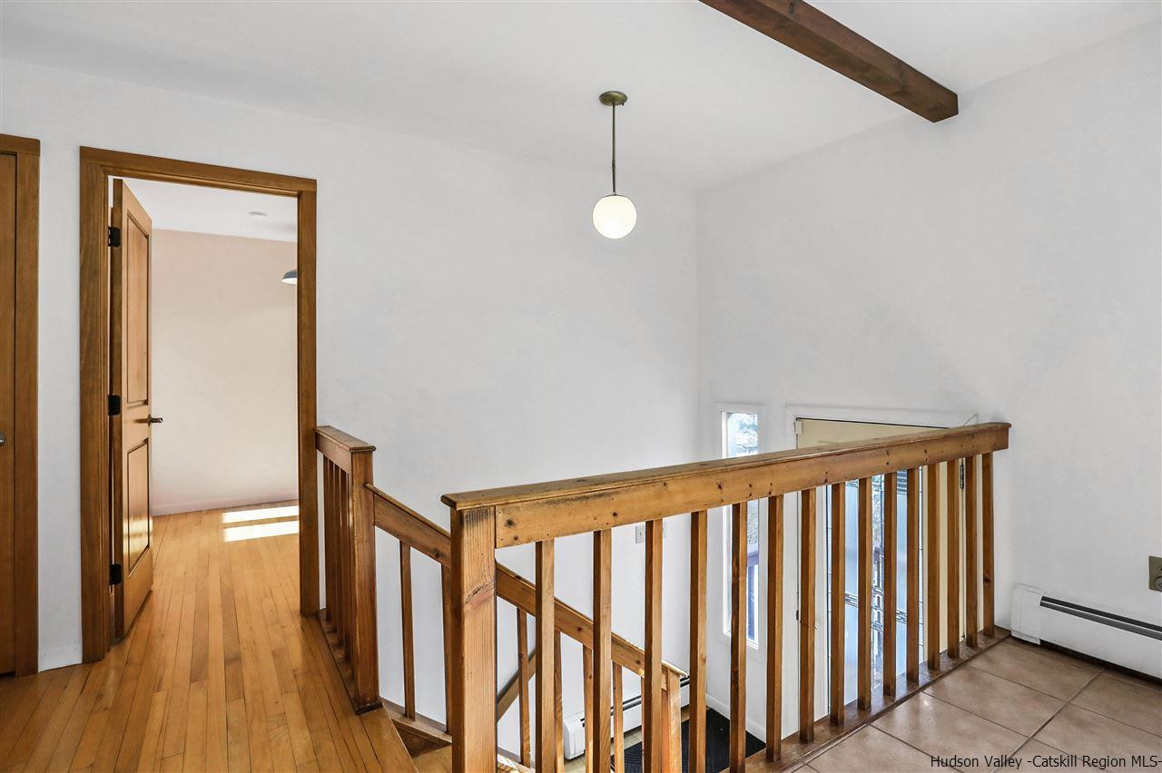 156 Sparkling Ridge Road New Paltz, NY 12561 - Photo 17 of 35 a view of a hallway with wooden floor and stairs