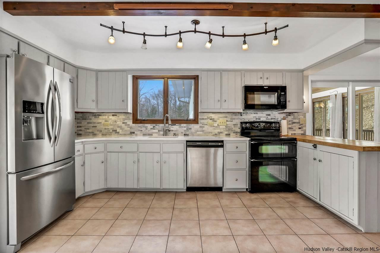 156 Sparkling Ridge Road New Paltz, NY 12561 - Photo 21 of 35 a kitchen with kitchen island granite countertop a stove sink and refrigerator