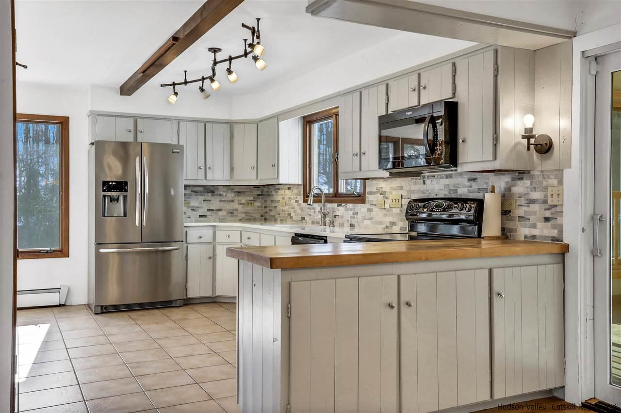 156 Sparkling Ridge Road New Paltz, NY 12561 - Photo 23 of 35 a kitchen with stainless steel appliances granite countertop a stove a sink and a refrigerator