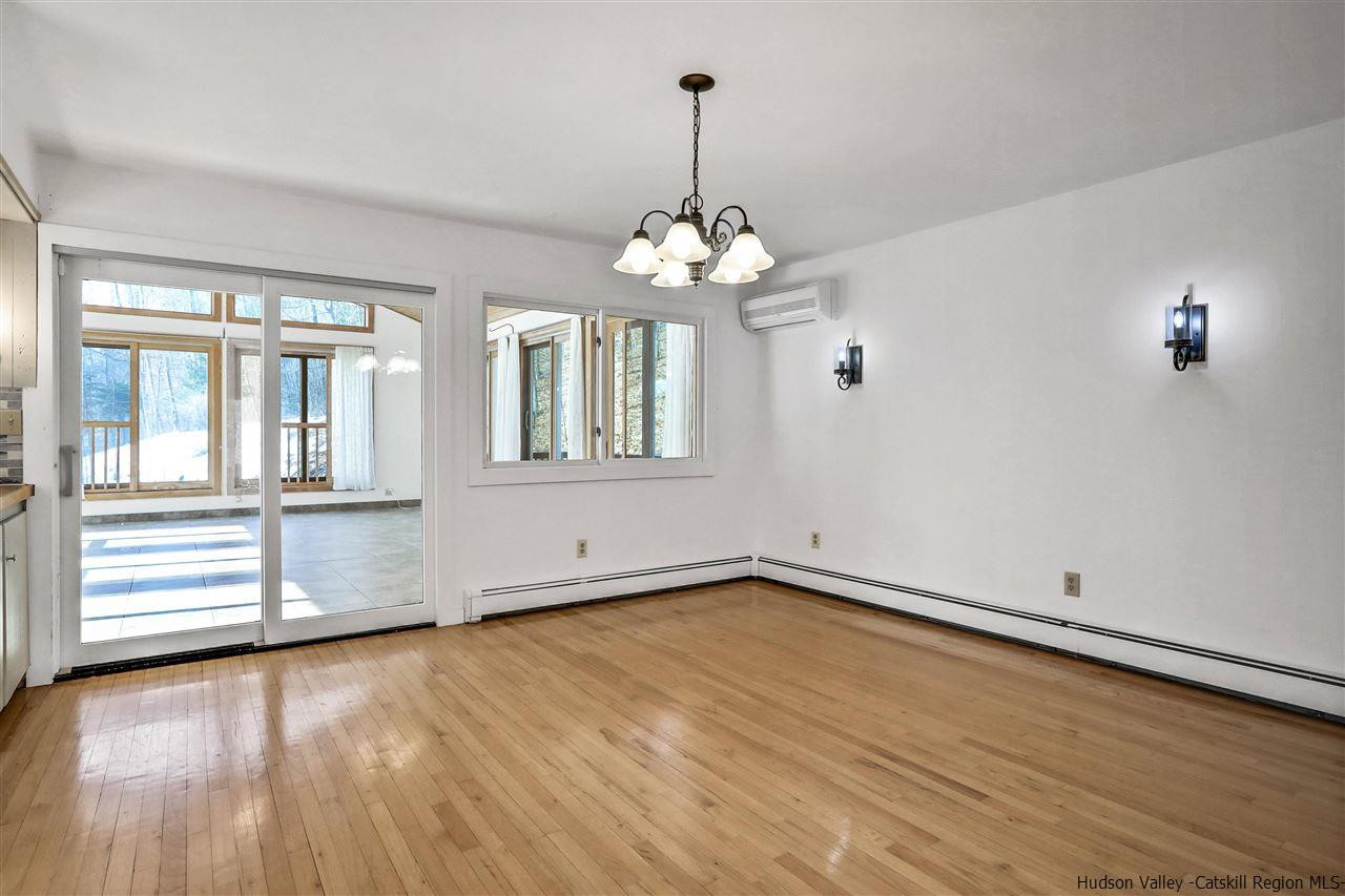156 Sparkling Ridge Road New Paltz, NY 12561 - Photo 24 of 35 an empty room with wooden floor and windows