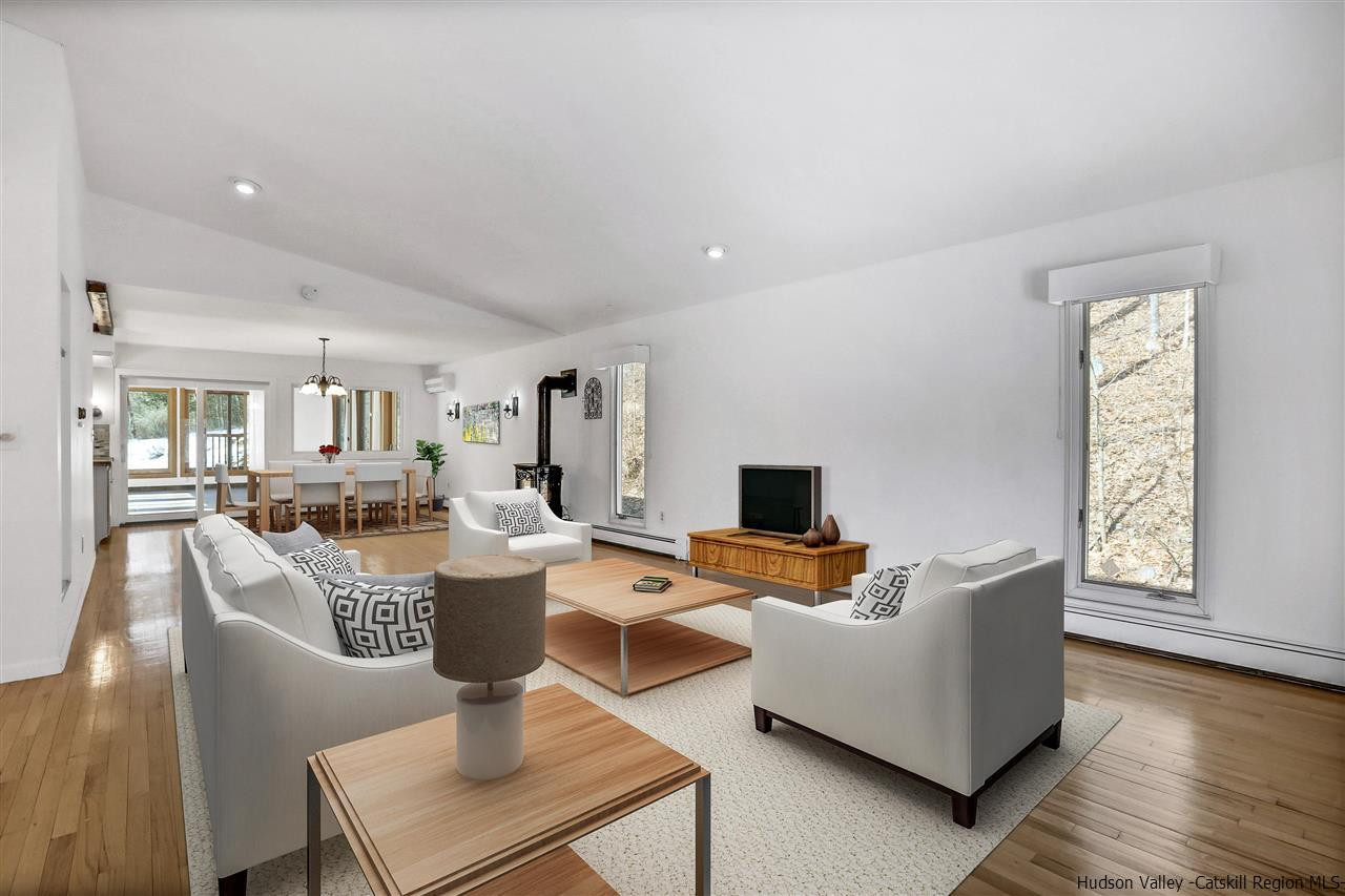 156 Sparkling Ridge Road New Paltz, NY 12561 - Photo 32 of 35 a living room with fireplace furniture and a wooden floor