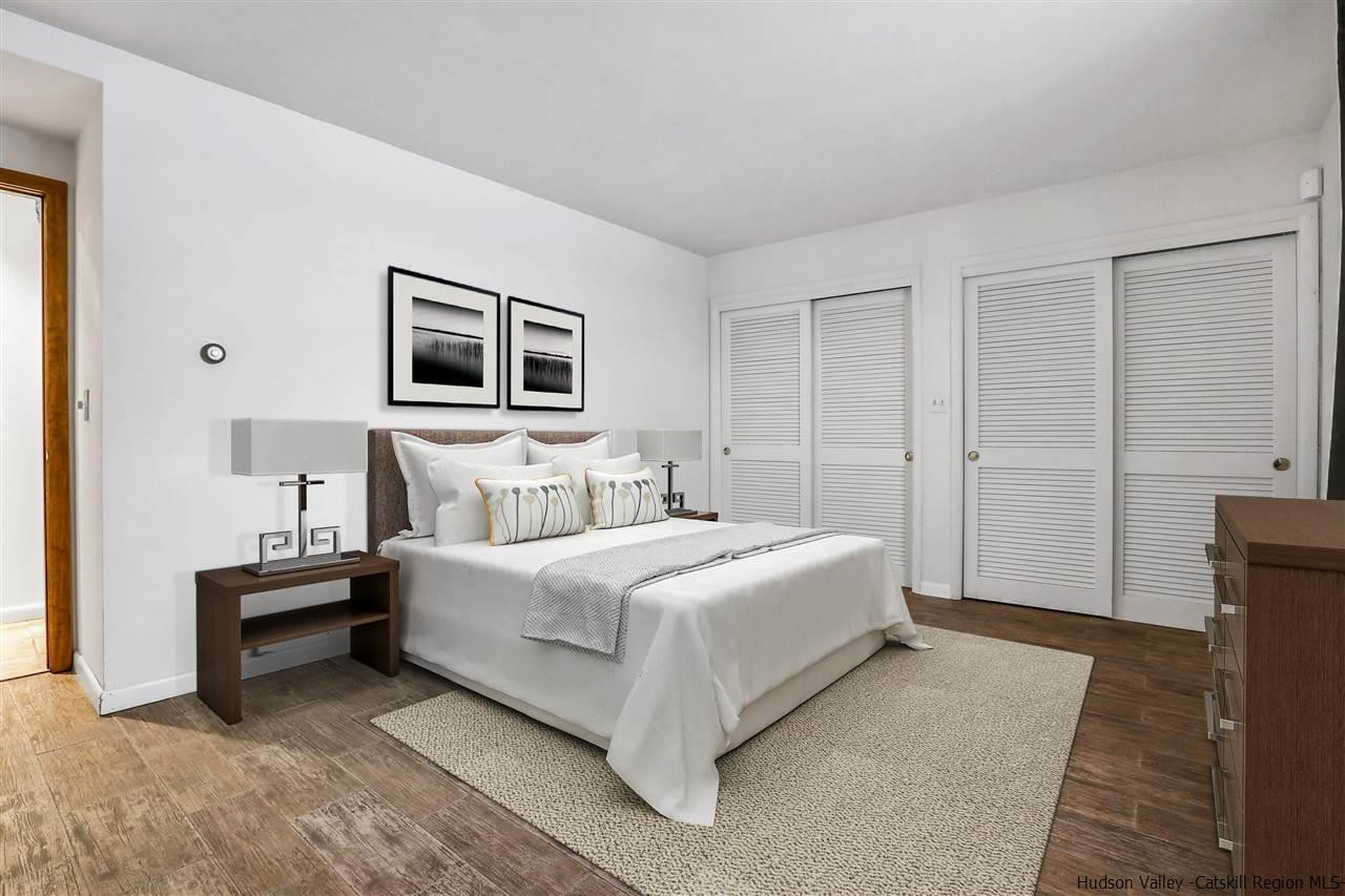 156 Sparkling Ridge Road New Paltz, NY 12561 - Photo 9 of 35 a bedroom with a bed and a night stand