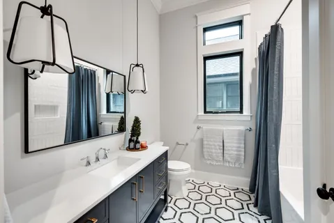 a bathroom with a double vanity sink mirror and shower