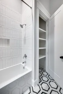 a bathroom with a bathtub and a shower