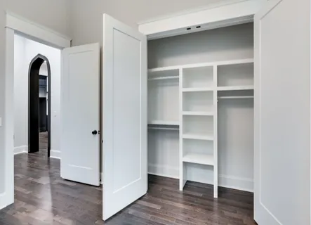 a view of walk in closet with empty racks