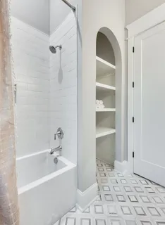 a bathroom with a bathtub and a shower