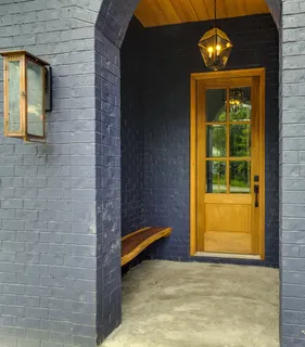 a view of backyard door with wooden floor
