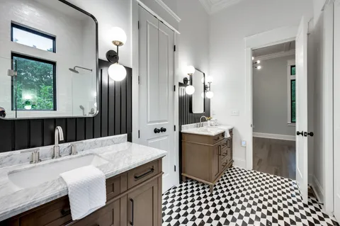 a bathroom with a sink vanity granite and a mirror