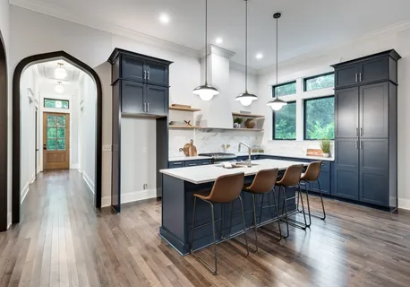 a kitchen with stainless steel appliances granite countertop wooden floors and sink