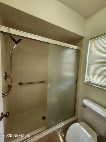 a bathroom with a shower and a toilet