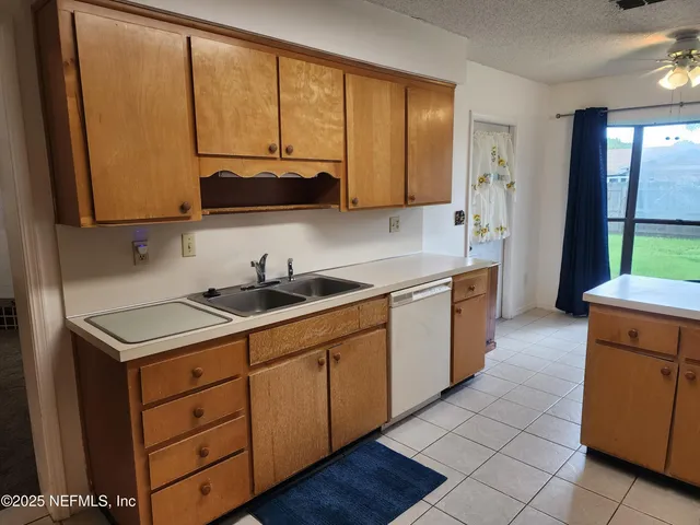 a kitchen with a sink cabinets and window