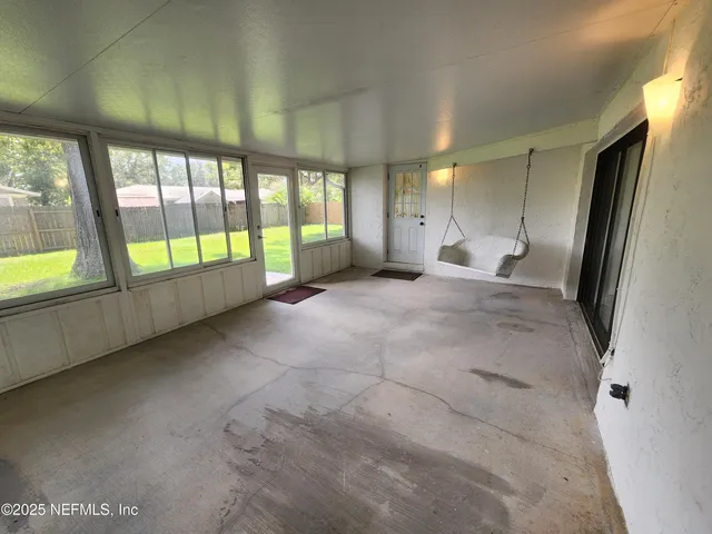 a view of an empty room and a window