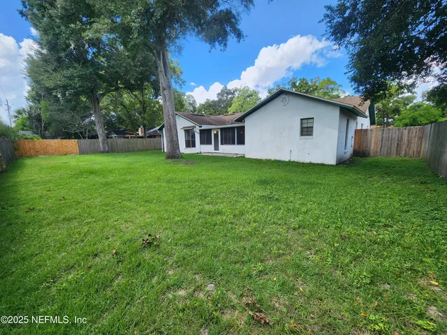 a house with green field in front of it